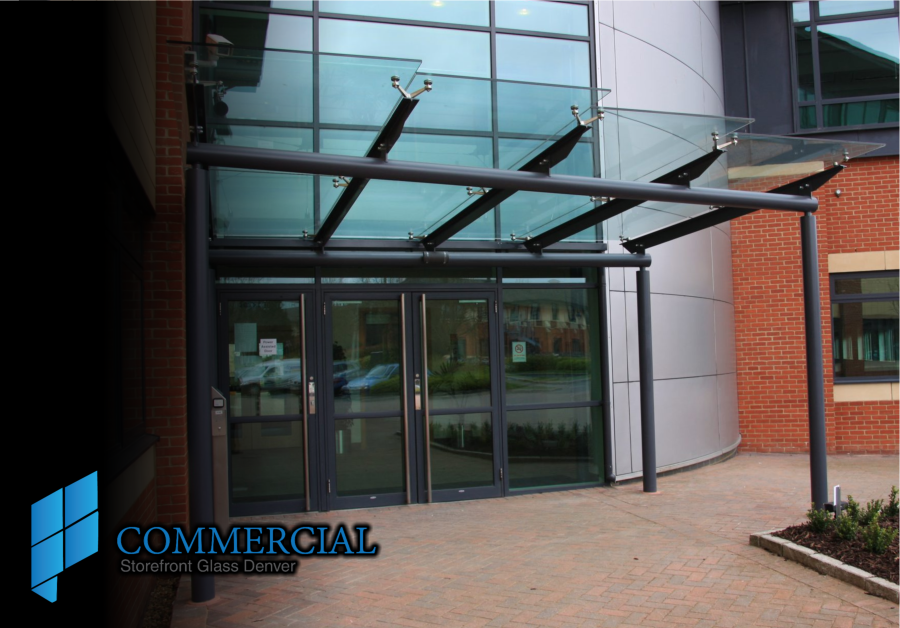 Commercial glass entrance with aluminum doors and a glass entry canopy