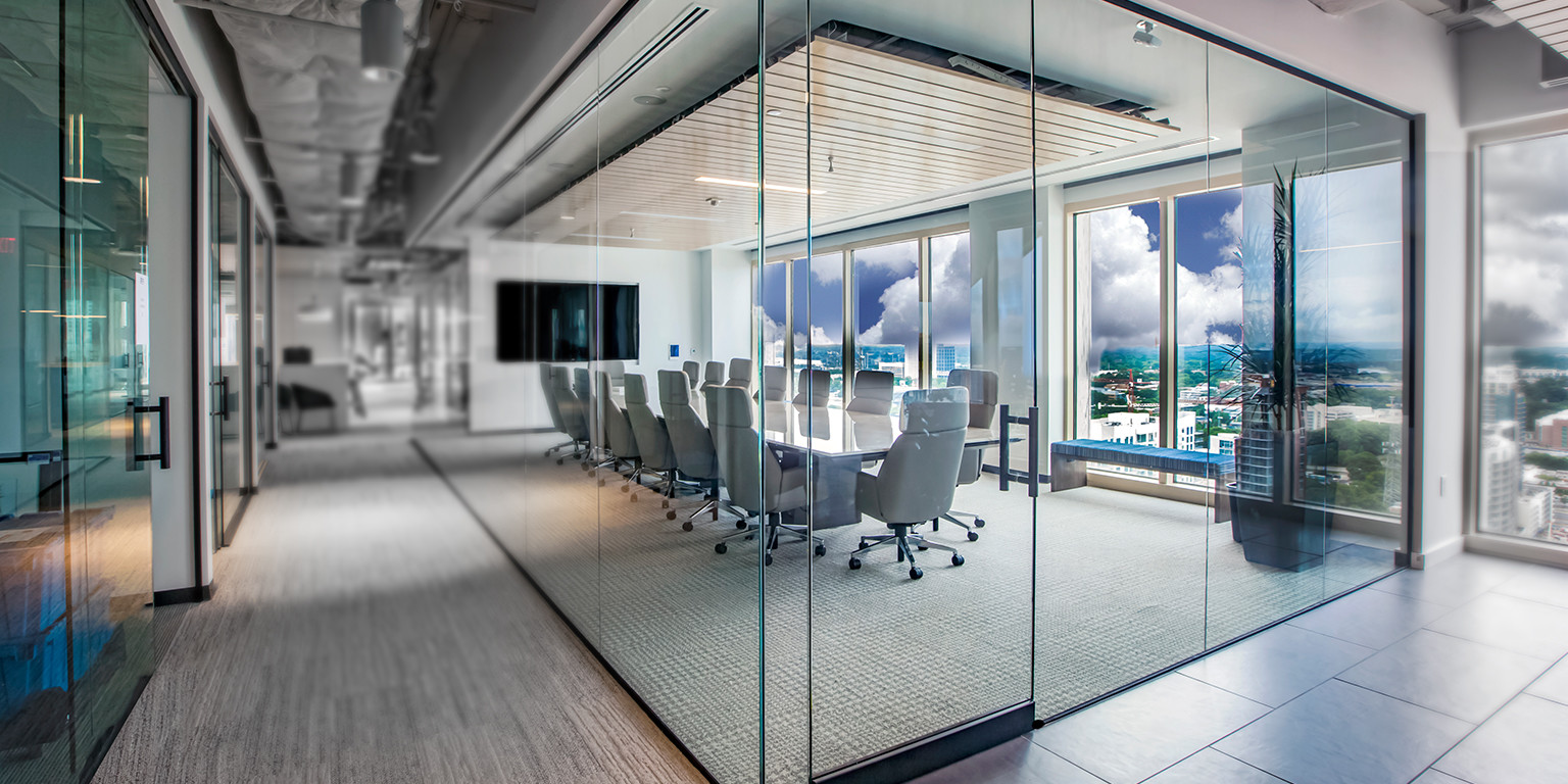 Frameless glass conference room and interior office fronts on a commercial tenant floor