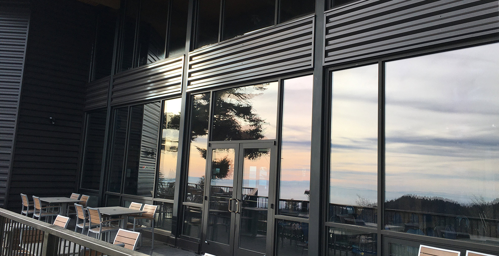Aluminum storefront and entrance doors at a restaurant with exterior patio seating